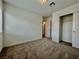 A cozy carpeted bedroom features a standard closet and entry door at 5699 Woodchester Ave, Las Vegas, NV 89139