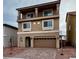 Two-story home featuring a balcony, tile roof, paver driveway, and two-car garage at 5699 Woodchester Ave, Las Vegas, NV 89139
