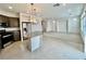 Modern kitchen with stainless steel appliances, granite countertops, and tile flooring at 5699 Woodchester Ave, Las Vegas, NV 89139
