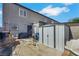 Backyard featuring gray house, cement, small metal storage shed, and a secured dog run at 6008 Pebble Beach Blvd, Las Vegas, NV 89108