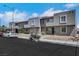 Street view of attached townhomes with stucco exteriors, desert landscaping, and parking at 6008 Pebble Beach Blvd, Las Vegas, NV 89108