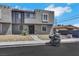 Townhome featuring stucco exterior, security bars on the first-floor windows, and minimal landscaping at 6008 Pebble Beach Blvd, Las Vegas, NV 89108