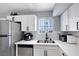 Updated kitchen featuring stainless steel appliances, white cabinets, and a stainless steel sink at 6008 Pebble Beach Blvd, Las Vegas, NV 89108