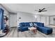 Cozy living room showing a blue sectional sofa, gray walls, and wood floors at 6008 Pebble Beach Blvd, Las Vegas, NV 89108