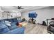 Comfortable living room featuring a blue sectional sofa and wood floors at 6008 Pebble Beach Blvd, Las Vegas, NV 89108