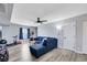Open living room featuring a comfy blue sectional sofa and neutral paint at 6008 Pebble Beach Blvd, Las Vegas, NV 89108