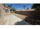 A long backyard with patio extension, rock ground cover, and tall privacy wall at 6113 Desert Haven Rd, Las Vegas, NV 89130