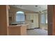 Bright kitchen featuring white cabinets, neutral tile and an eat-in nook by a large window at 6113 Desert Haven Rd, Las Vegas, NV 89130