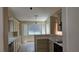Bright kitchen featuring white cabinets, neutral tile and an eat-in nook by a large window at 6113 Desert Haven Rd, Las Vegas, NV 89130