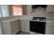 Traditional kitchen features tile countertops, bright cabinets, and a black gas range at 6113 Desert Haven Rd, Las Vegas, NV 89130