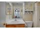 Light-filled bathroom featuring a shower-tub combo, wood vanity, and tile flooring at 622 Quaint Acres Ave, Las Vegas, NV 89183
