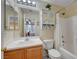 Bright bathroom features a shower-tub combo and a wood vanity at 622 Quaint Acres Ave, Las Vegas, NV 89183