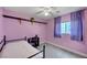 Cozy bedroom featuring carpet flooring, purple walls, and a ceiling fan at 622 Quaint Acres Ave, Las Vegas, NV 89183
