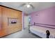 Cozy bedroom features built-in storage, a single bed, and lilac-colored walls for a peaceful ambiance at 622 Quaint Acres Ave, Las Vegas, NV 89183