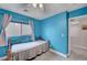 Inviting bedroom features a window, cozy bed, and a tranquil atmosphere, enhanced by the soft blue walls at 622 Quaint Acres Ave, Las Vegas, NV 89183