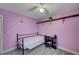 Bright bedroom boasts carpet flooring, purple walls, and a desk at 622 Quaint Acres Ave, Las Vegas, NV 89183