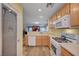 Kitchen showcasing wood cabinets, gas range, and glass-door pantry at 622 Quaint Acres Ave, Las Vegas, NV 89183