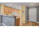 Eat-in kitchen with wood cabinets, a breakfast bar, and bright lighting at 622 Quaint Acres Ave, Las Vegas, NV 89183