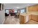 Open-concept living space connects kitchen, dining, and living areas, with wood-look floors at 622 Quaint Acres Ave, Las Vegas, NV 89183