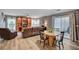 Comfortable living area featuring wood-look floors, updated colors, and a sliding patio door at 622 Quaint Acres Ave, Las Vegas, NV 89183