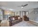 Comfortable living area with a ceiling fan, wood-look floors, and updated paint colors at 622 Quaint Acres Ave, Las Vegas, NV 89183