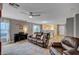 Open living room with a ceiling fan, wood floors, and seamless flow to kitchen area at 622 Quaint Acres Ave, Las Vegas, NV 89183