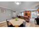 Open-concept living area featuring wood-look floors, updated colors, and a staircase to the left at 622 Quaint Acres Ave, Las Vegas, NV 89183