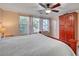 Bright main bedroom featuring a ceiling fan, wardrobe, and multiple windows at 622 Quaint Acres Ave, Las Vegas, NV 89183