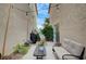 Cozy patio area featuring a comfortable bench, bistro table, and charming string lights for outdoor enjoyment at 622 Quaint Acres Ave, Las Vegas, NV 89183