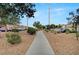 Walking path in common area with trees and desert landscaping; street parking is available at 622 Quaint Acres Ave, Las Vegas, NV 89183