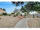 Community walking path surrounded by desert landscaping, rocks, trees and lush green shrubs at 622 Quaint Acres Ave, Las Vegas, NV 89183