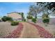 Beautiful walkway with rocks and desert landscaping leading to grassy common area at 622 Quaint Acres Ave, Las Vegas, NV 89183