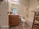 Well-lit bathroom featuring a bathtub and vanity with wooden cabinets and a neutral color scheme at 6313 Snap Ridge St # 201, North Las Vegas, NV 89081