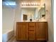 Bathroom featuring double sinks and a bathtub, illuminated with stylish vanity lighting at 6313 Snap Ridge St # 201, North Las Vegas, NV 89081