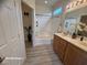Well-lit bathroom featuring double sinks and a bathtub, with bright, natural light at 6313 Snap Ridge St # 201, North Las Vegas, NV 89081