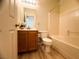 Well-lit bathroom featuring a bathtub and vanity with wooden cabinets and a neutral color scheme at 6313 Snap Ridge St # 201, North Las Vegas, NV 89081