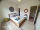 Bright bedroom featuring a wood frame bed, neutral walls, and fun décor at 6313 Snap Ridge St # 201, North Las Vegas, NV 89081