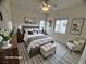 Cozy bedroom features a ceiling fan, comfortable bed with stylish linens, and bright natural lighting at 6313 Snap Ridge St # 201, North Las Vegas, NV 89081