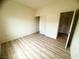 Simple bedroom features modern hard surface floors, neutral walls, and a double door closet at 6313 Snap Ridge St # 201, North Las Vegas, NV 89081
