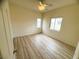 Bright bedroom with a ceiling fan, neutral walls, and hardwood floors create a serene and inviting space at 6313 Snap Ridge St # 201, North Las Vegas, NV 89081