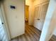 Hallway view of a bathroom and closet with louvered doors at 6313 Snap Ridge St # 201, North Las Vegas, NV 89081