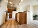 Kitchen island with wood cabinets, stainless steel appliances, and wood-look floors at 6313 Snap Ridge St # 201, North Las Vegas, NV 89081