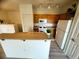 Kitchen area showcasing oak cabinets and white appliances with a breakfast bar at 6313 Snap Ridge St # 201, North Las Vegas, NV 89081