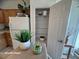 Kitchen space with pantry, oak cabinets, white appliances, and lots of counter space at 6313 Snap Ridge St # 201, North Las Vegas, NV 89081