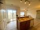 Bright kitchen with island, appliances, and sliding doors leading to a balcony with outdoor space at 6313 Snap Ridge St # 201, North Las Vegas, NV 89081
