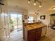 Bright kitchen with island, appliances, and sliding doors leading to a balcony with outdoor space at 6313 Snap Ridge St # 201, North Las Vegas, NV 89081