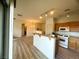 Open kitchen with a breakfast bar overlooking the dining area and wood-look floors at 6313 Snap Ridge St # 201, North Las Vegas, NV 89081