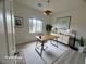 Home office with a warm color palette, minimalist décor, and natural light at 6313 Snap Ridge St # 201, North Las Vegas, NV 89081