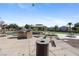Community playground featuring multiple picnic tables, charcoal grill, and green turf at 6313 Snap Ridge St # 201, North Las Vegas, NV 89081