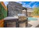 Outdoor kitchen with built-in grill and counter space, poolside, perfect for entertaining and relaxation at 6630 Virtuoso Ct, Las Vegas, NV 89139